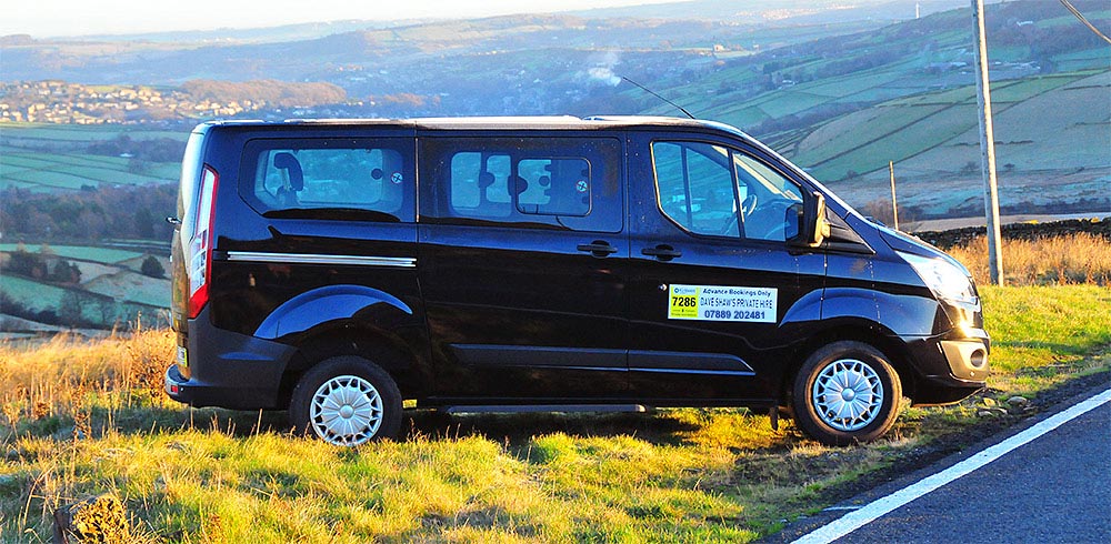 DAve Shaws Private Hire minibus overlook Huddersfield countryside.